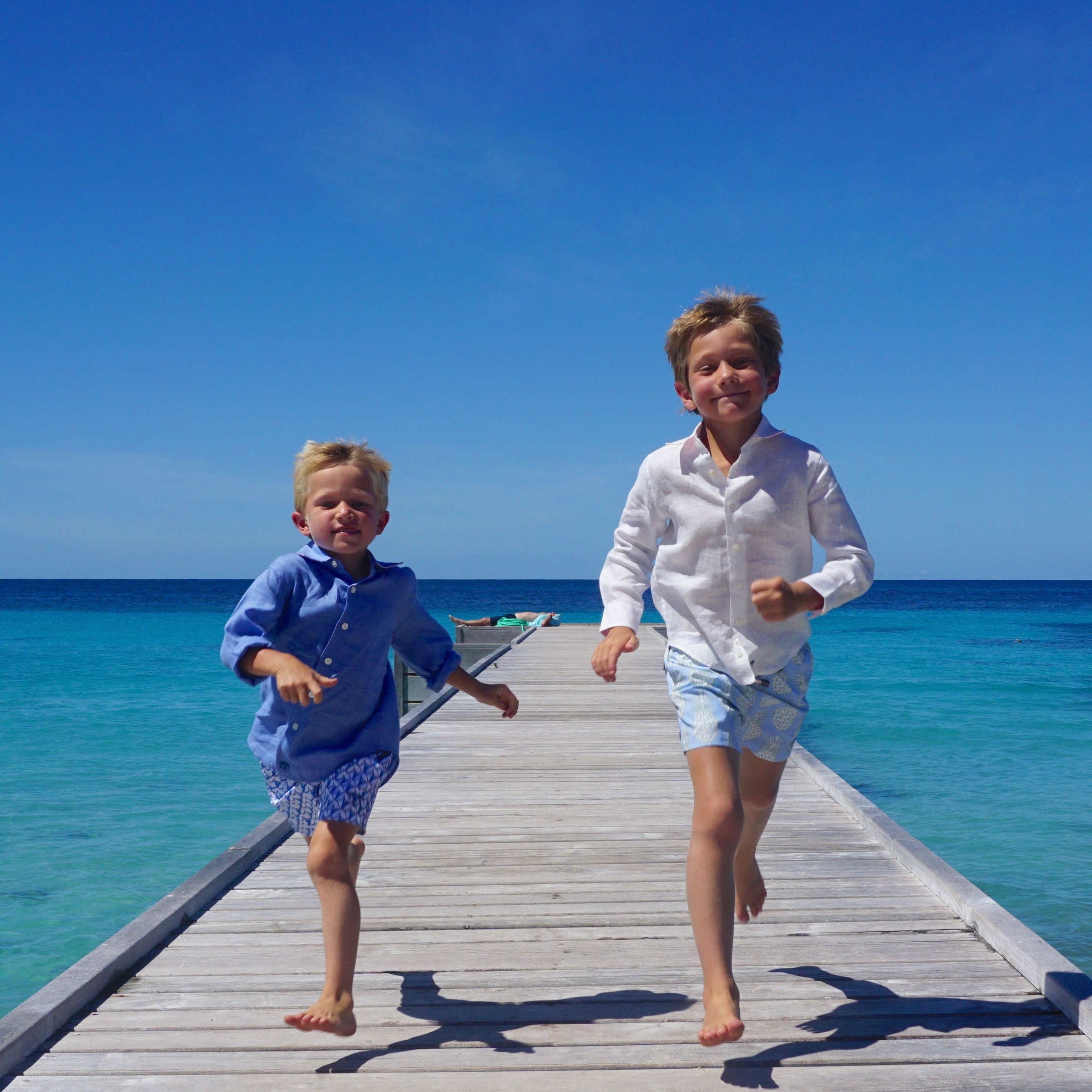 Boys swim trunks : PINEAPPLE PRICKLES - BLUE children running on pontoon Mustique