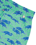 Pocket detail of sustainable Mens swim shorts in green & blue Egret bird print by Lotty B Mustique