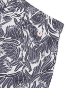 Back pocket detail of mens swim shorts in navy blue floral Protea print by designer Lotty B for Pink House Mustique