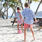 Kids holiday swim shorts in turquoise blue and coral red Striped Shell print by designer Lotty B