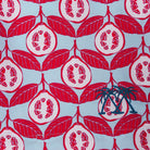 Swim shorts fabric swatch in Guava red print by Lotty B Mustique resort wear