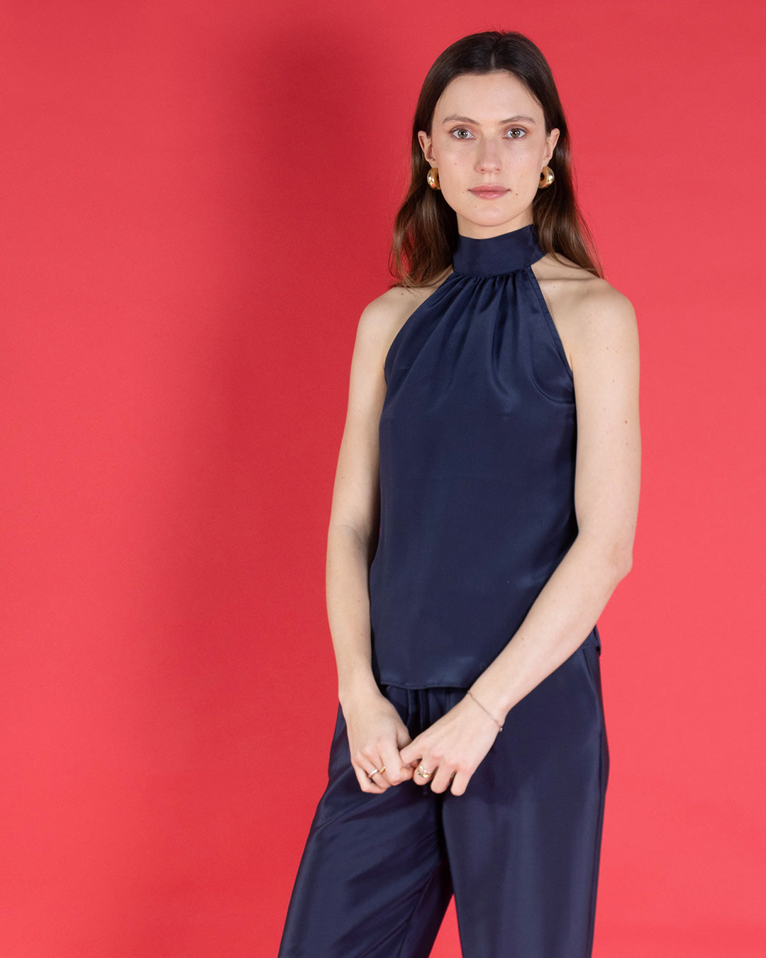 Sophisticated silk ensemble Olivia halter top, in navy blue crepe de Chine silk worn with matching Marina pants. Pink House Atelier collection by designer Lotty B