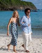 Chic vacation style, Mustique picnics on Lagoon bay in a blue Sand Dollar shirt worn with classic white linen pants and made-to-order long silk Kate dress by designer Lotty B for Pink House