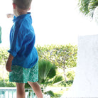 Kids beach style in green floral Protea print swim shorts