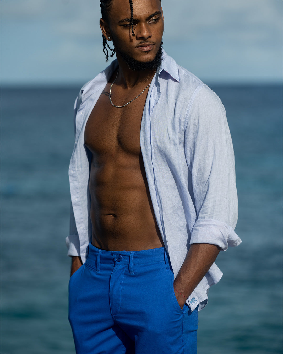 Beach style linen pants in dazzling blue worn with pale blue linen shirt. Resortwear by Pink House 