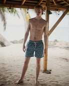 Tropical beach vacation essentials for men, recycled swim shorts in Sand Dollar blue by Pink House Mustique