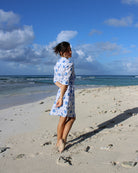 Women's chic linen holiday dress in blue Turtle print on Lagoon beach, Mustique Island