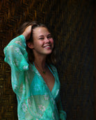 Chic holiday style, chiffon silk Kimono cover-up in green Sand Dollar print, Mustique holiday lifestyle at Basil's Bar.