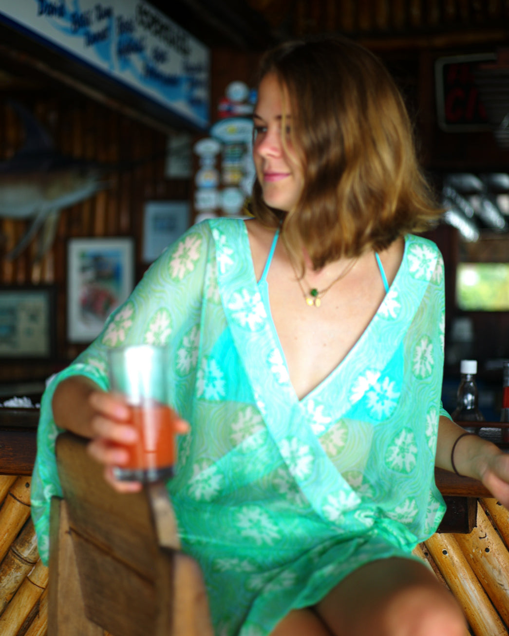 Elegant resortwear, chiffon silk Kimono cover-up in green Sand Dollar print, Mustique holiday lifestyle at Basil's Bar.