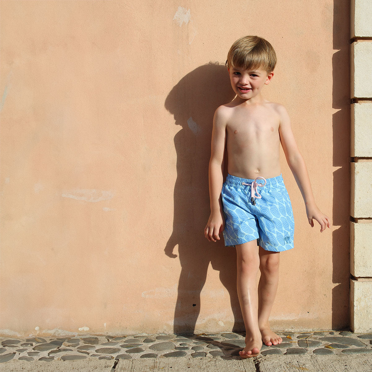 Boys soft quick-dry swim shorts in blue Striped Shell print by designer Lotty B