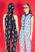 two women with matching silk two piece outfits