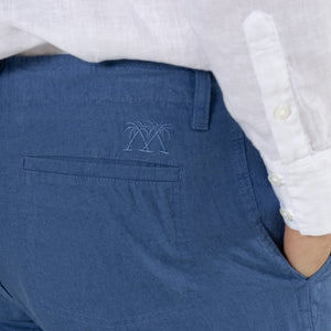 Designer casual blue pure linen pants worn with collarless white shirt by Pink House resortwear