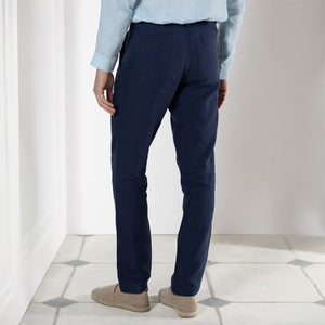 Designer pure linen pants in eclipse navy blue worn with pale blue linen shirt