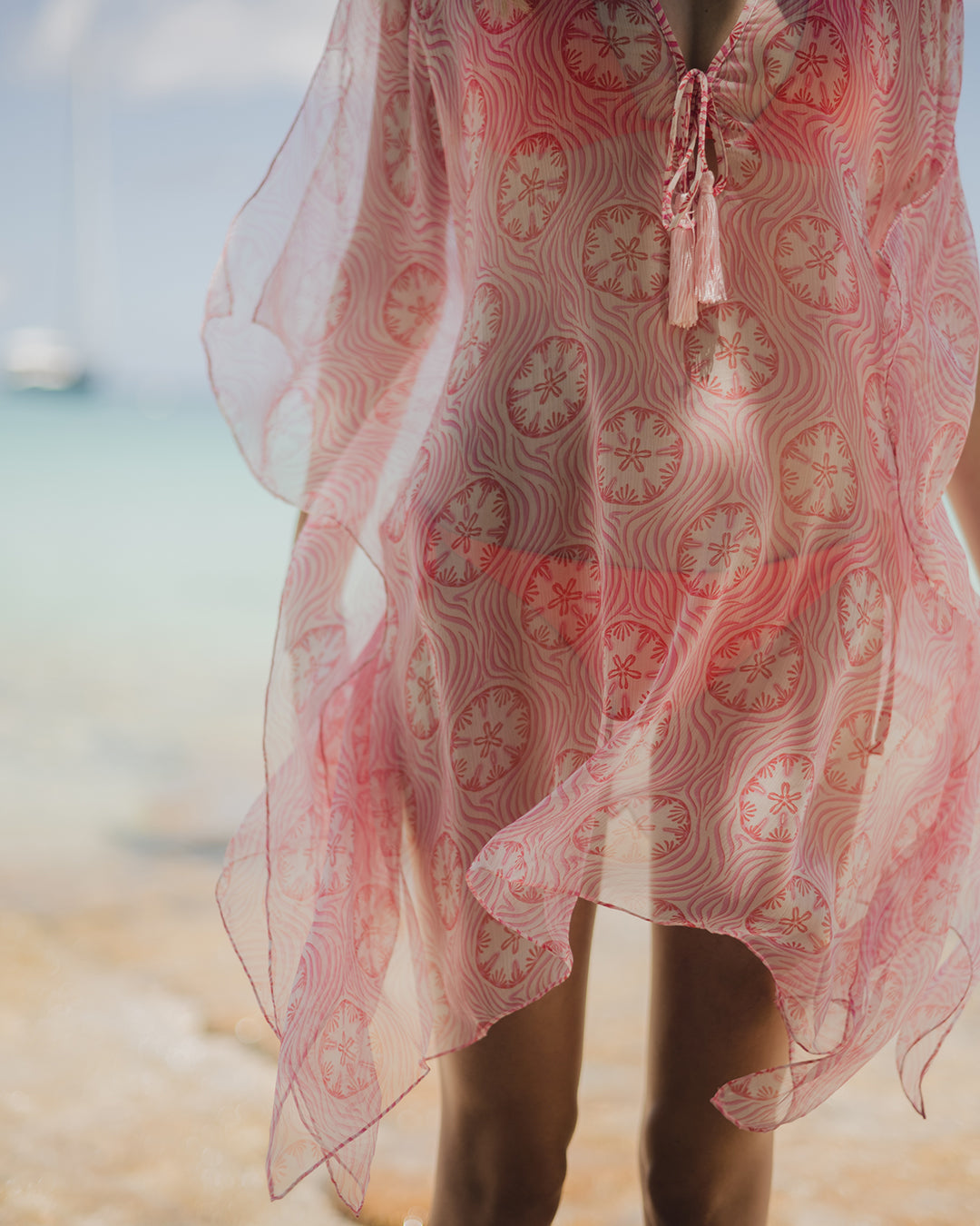 Tropical beach resort vacation style, silk chiffon Cosima kaftan in coral pink Sand Dollar print by designer Lotty B , Britannia Bay Mustique