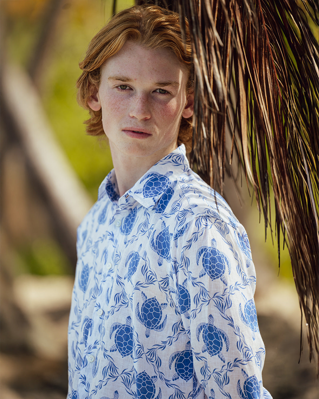 Man wearing a fun beach holiday line shirt on Mustique in blue Turtle Trellis pattern