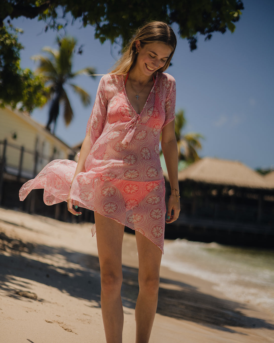 Luxury resort holiday style, silk chiffon Cosima kaftan in coral pink Sand Dollar print by designer Lotty B for Pink House