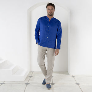 Vacation style casual linen pants worn with dazzling blue collarless linen shirt