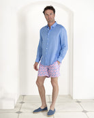 Mens designer holiday style swim shorts in Sand Dollar pink and blue styled with plain French Blue linen shirt by Pink House Mustique