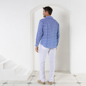 Tropical island style white linen pants worn with striped shell blue print shirt by Pink House resortwear