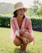 Tropical island holiday styles by designer Lotty B, chiffon silk Kimono in coral pink Sand Dollar, frangipani flowers in the garden, Villa Taliesin Mustique Island