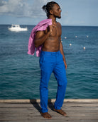 Island style linen pants in dazzling blue worn on cotton house pier Mustique island. Resortwear by Pink House 