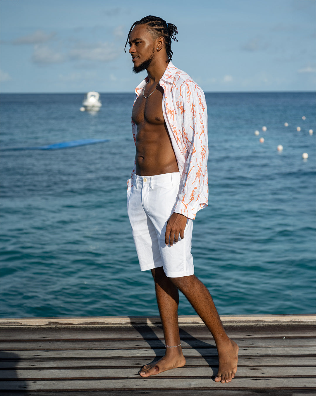 Classic island vacation style mens white linen shorts worn with fruit punch orange linen shirt by Pink House, cotton house deck Mustique island