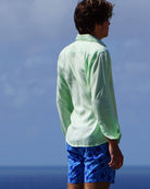 Mens holiday shirt solid green worn with blue swim shorts in pomegranate print by designer Lotty B for Pink House Mustique 