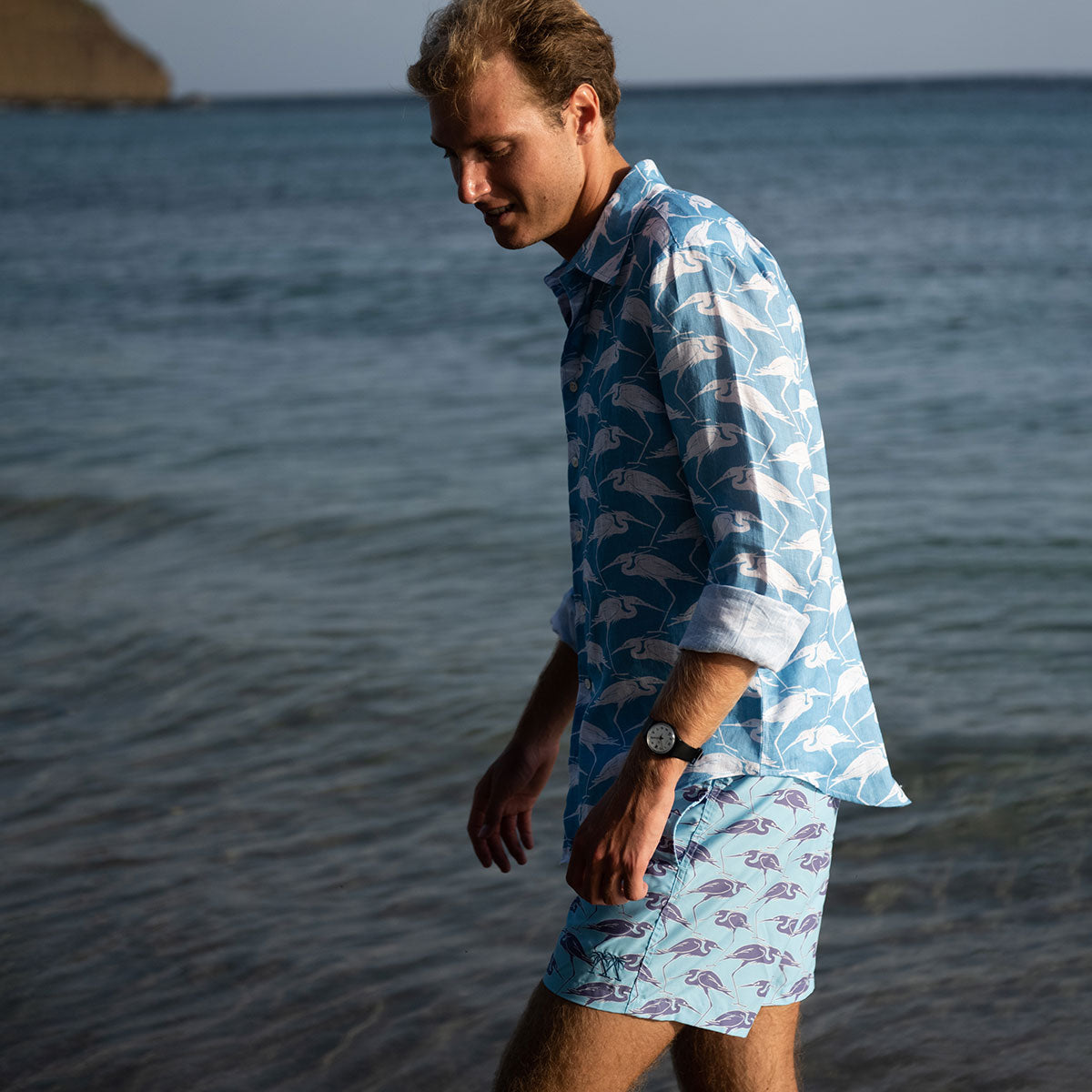 Sustainable Mens tropical vacation shorts in blue Egret bird print Cotton House pier, Mustique