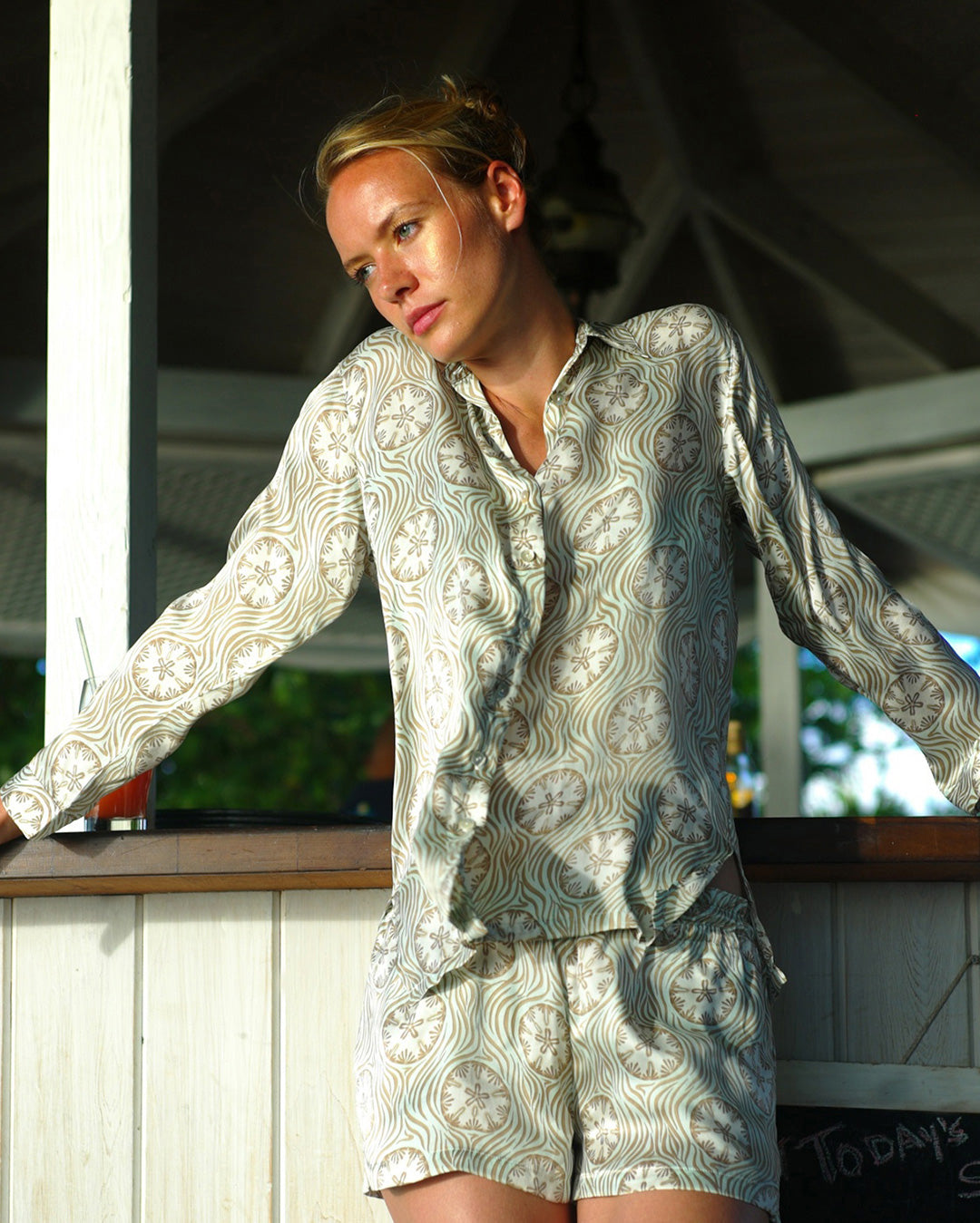 Pure silk shirt in pale blue and taupe sand dollar print by resortwear designer Lotty B, Cotton House Beach Bar Mustique