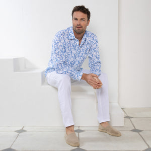 Perfect vacation style casual white linen pants worn with parrot blue print shirt by Pink House resortwear