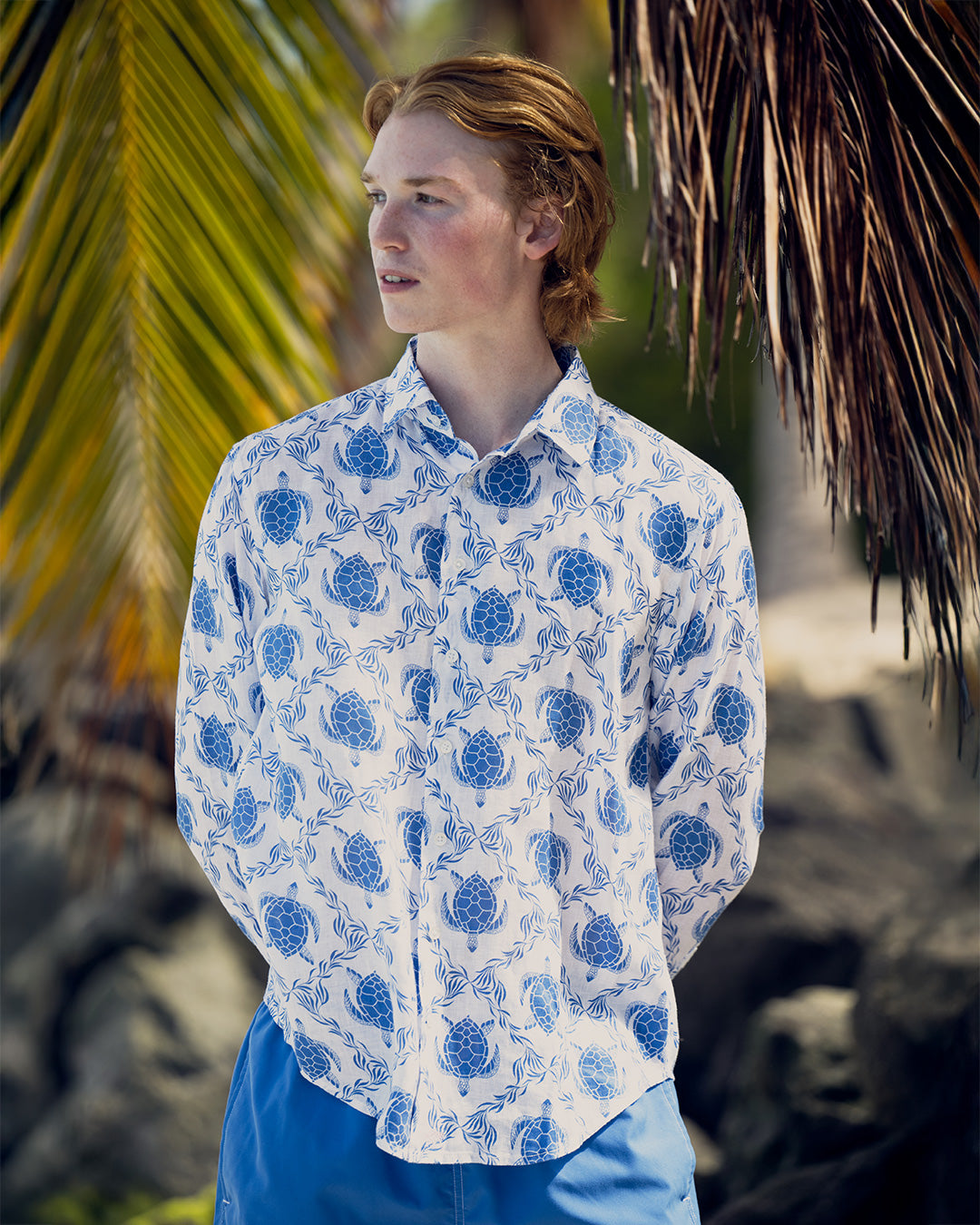 Man on tropical vacation in quality linen shirt with blue Turtle Trellis design