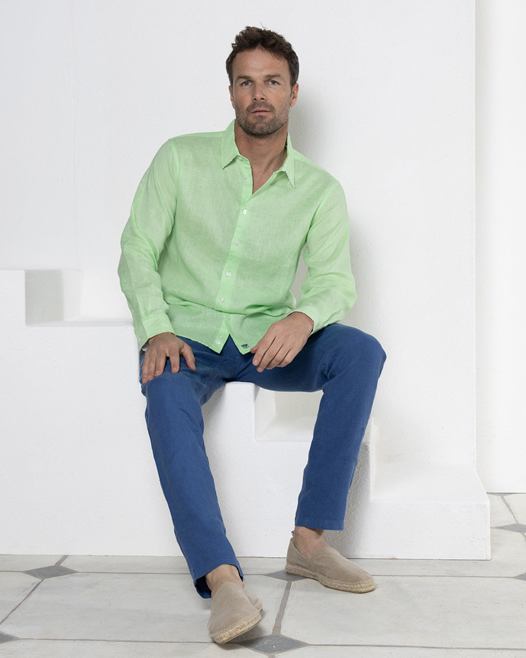 Men's vacation style blue linen pants worn with pistachio green shirt by Pink House resortwear