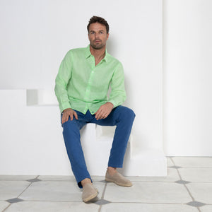 Men's vacation style blue linen pants worn with pistachio green shirt by Pink House resortwear