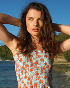 Luxury vacation style silk shirred bandeau top in pale blue and orange floral Flamboyant Flower print by designer Lotty B Mustique