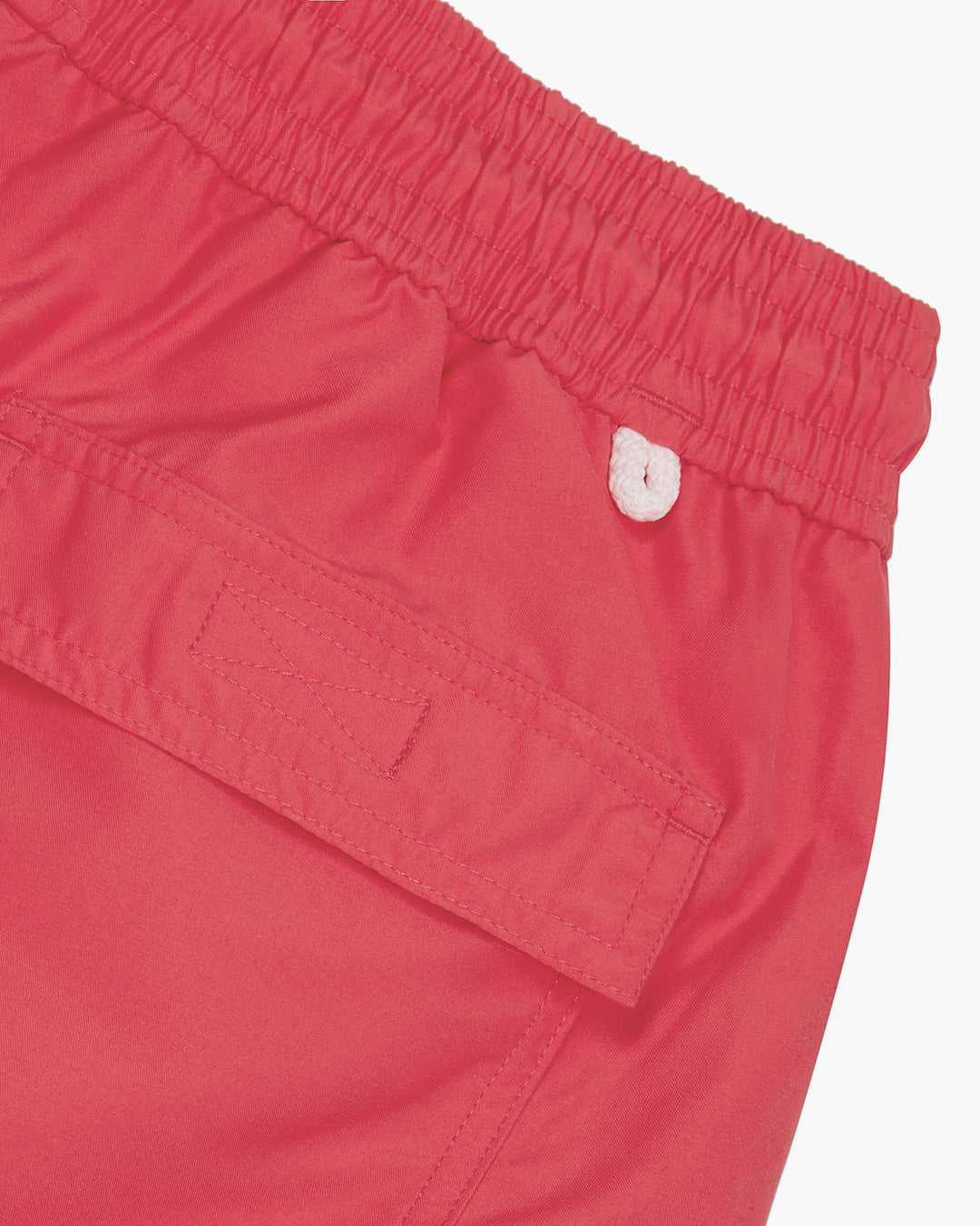 Back pocket and waistband detail for mens swim shorts solid faded red designer Lotty B Mustique for Pink House holiday essentials