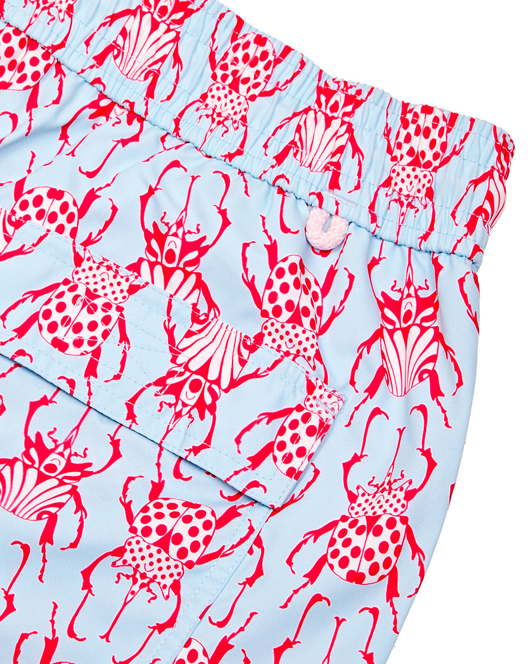 Back pocket and waistband detail for kids swim shorts in red and pale blue Beetle print by Lotty B for Pink House