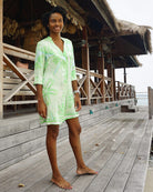 Styling luxury resort vacation brand Lotty B at Basil's Bar, Mustique Island. Pure silk buttoned shirt dress in green Sand Dollar print.