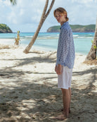 Beach lifestyle in a blue Sand Dollar print pure linen shirt by designer Lotty B for Pink House on Lagoon Bay, Mustique island