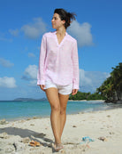 Women's pretty pink linen Kim shirt in Pangolin print worn with classic white linen shorts on Lagoon Bay, Mustique island