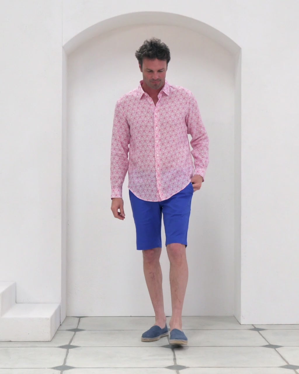 Men's pure linen shirt in pink Sand Dollar print worn with dazzling blue stretch linen shorts by designer Lotty B for Pink House