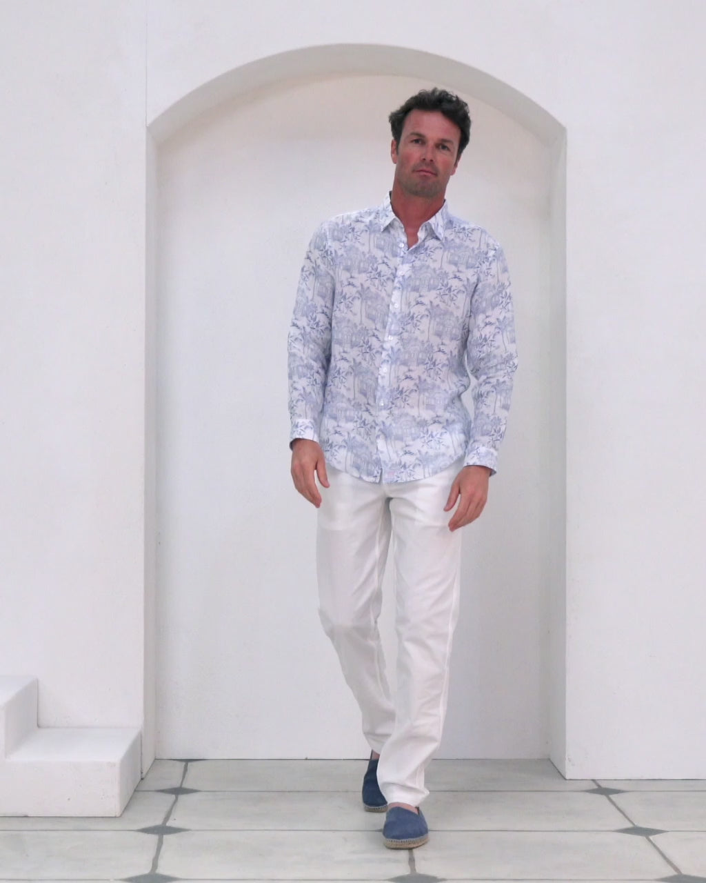 Pure linen shirt in Pink House Toile de Jouy print modelled by Joss with classic white linen trousers