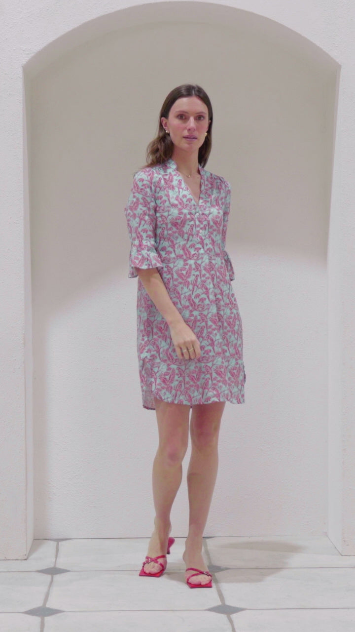 See a Pink House classic style, the Decima Dress, being worn by a model in the Parrot coral/turquoise print