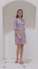 See a Pink House classic style, the Decima Dress, being worn by a model in the Parrot coral/turquoise print