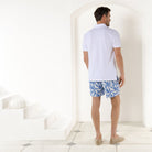 Resort style men's swim shorts in blue Parrot print by designer Lotty B