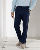 Resortwear pure linen pants in eclipse navy blue worn with pale blue linen shirt