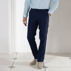 Resortwear pure linen pants in eclipse navy blue worn with pale blue linen shirt