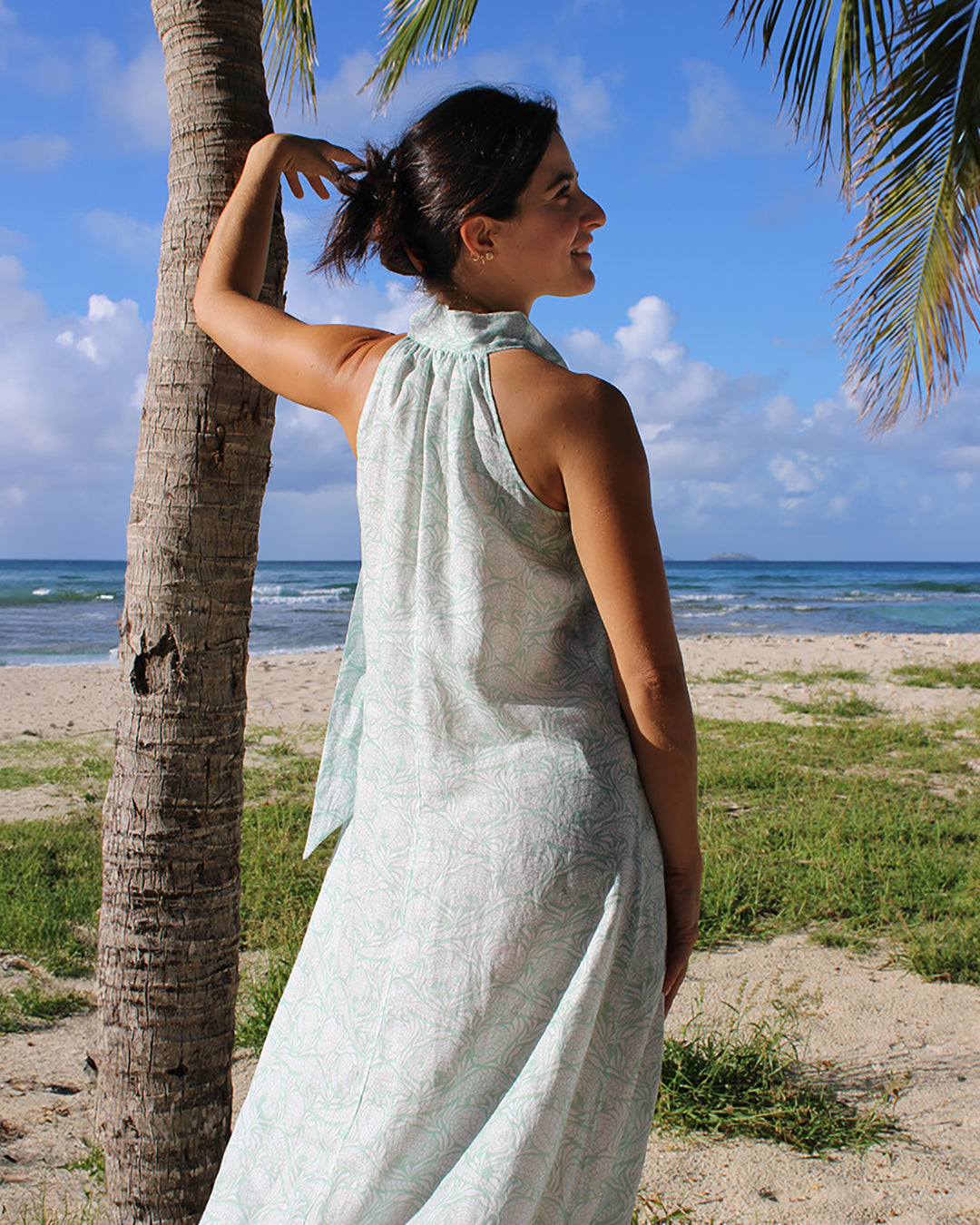 Long linen Trinny dress in green Pangolin design, worn by Francesca on Lagoon beach, Mustique Island by Pink House