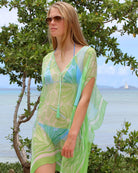 Luxury resort vacation style, chiffon silk Cosima Kaftan in green Sand Dollar print by designer Lotty B, Lagoon beach, Mustique Island.