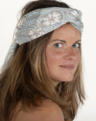 Long silk scarf in pale blue and taupe Sand Dollar print tied as a head scarf