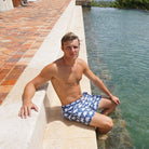 Mens swim trunks : FAN PALM - NAVY, by the pool Mustique